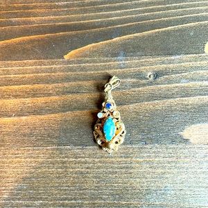 Antique gold tone pendant. One missing stone but really beautiful.
